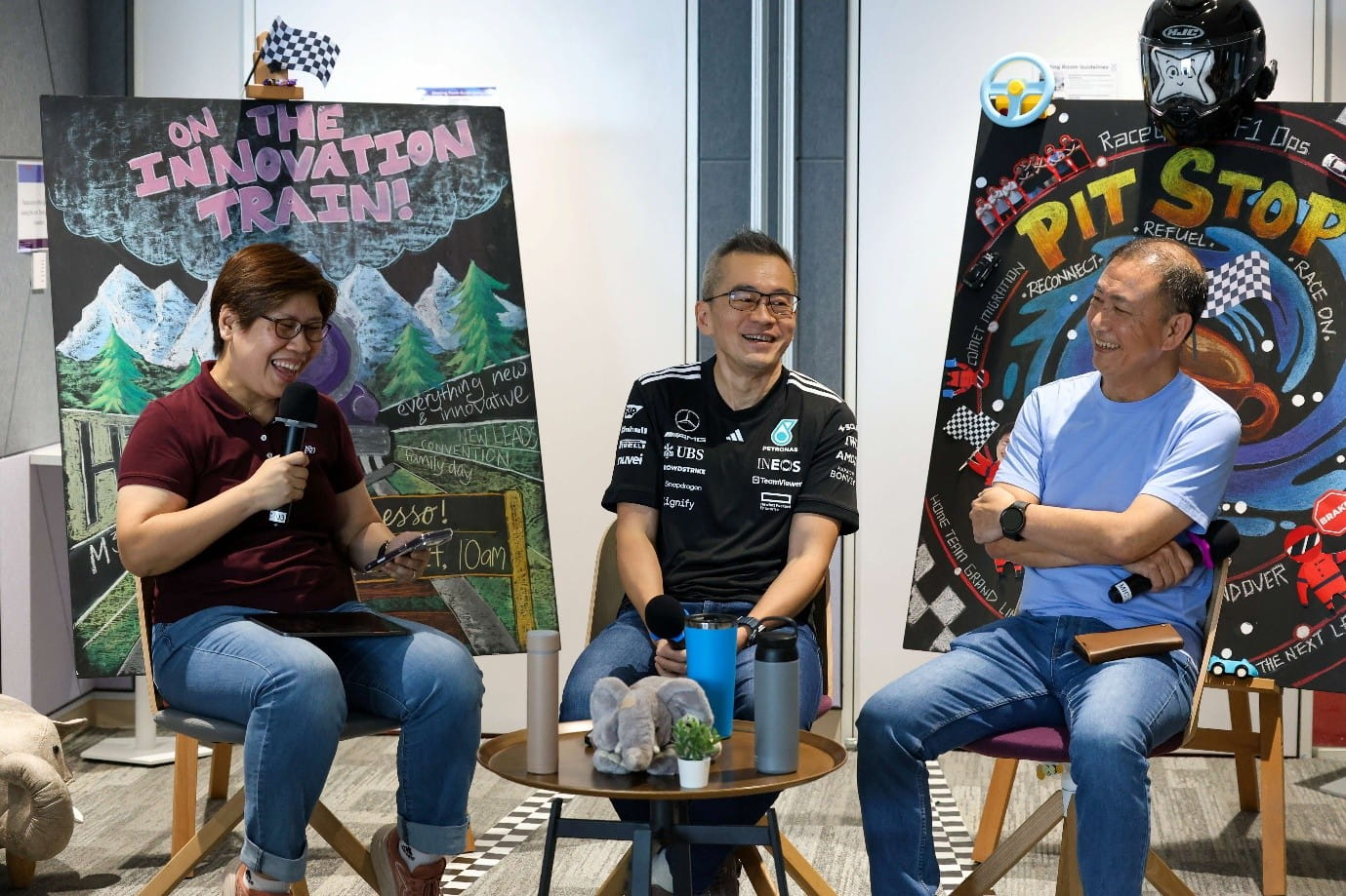 Three people participating in a seated panel discussion.