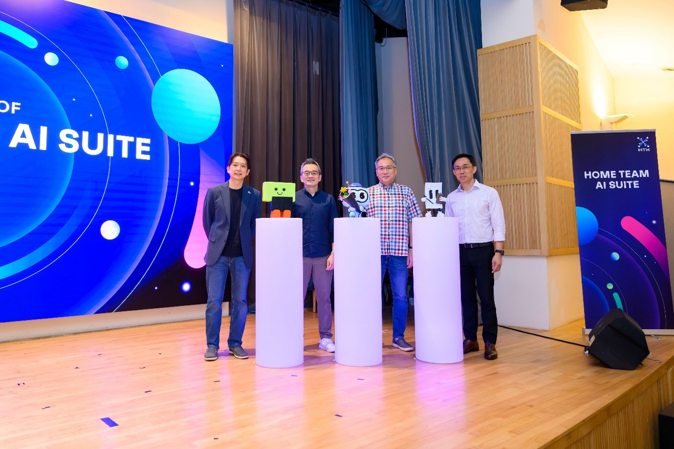 Four men stand on stage at the "Home Team AI Suite" launch event.
