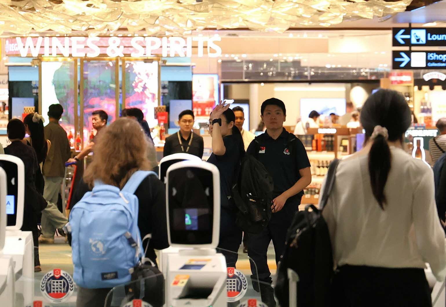 A person waves goodbye after clearance checks.