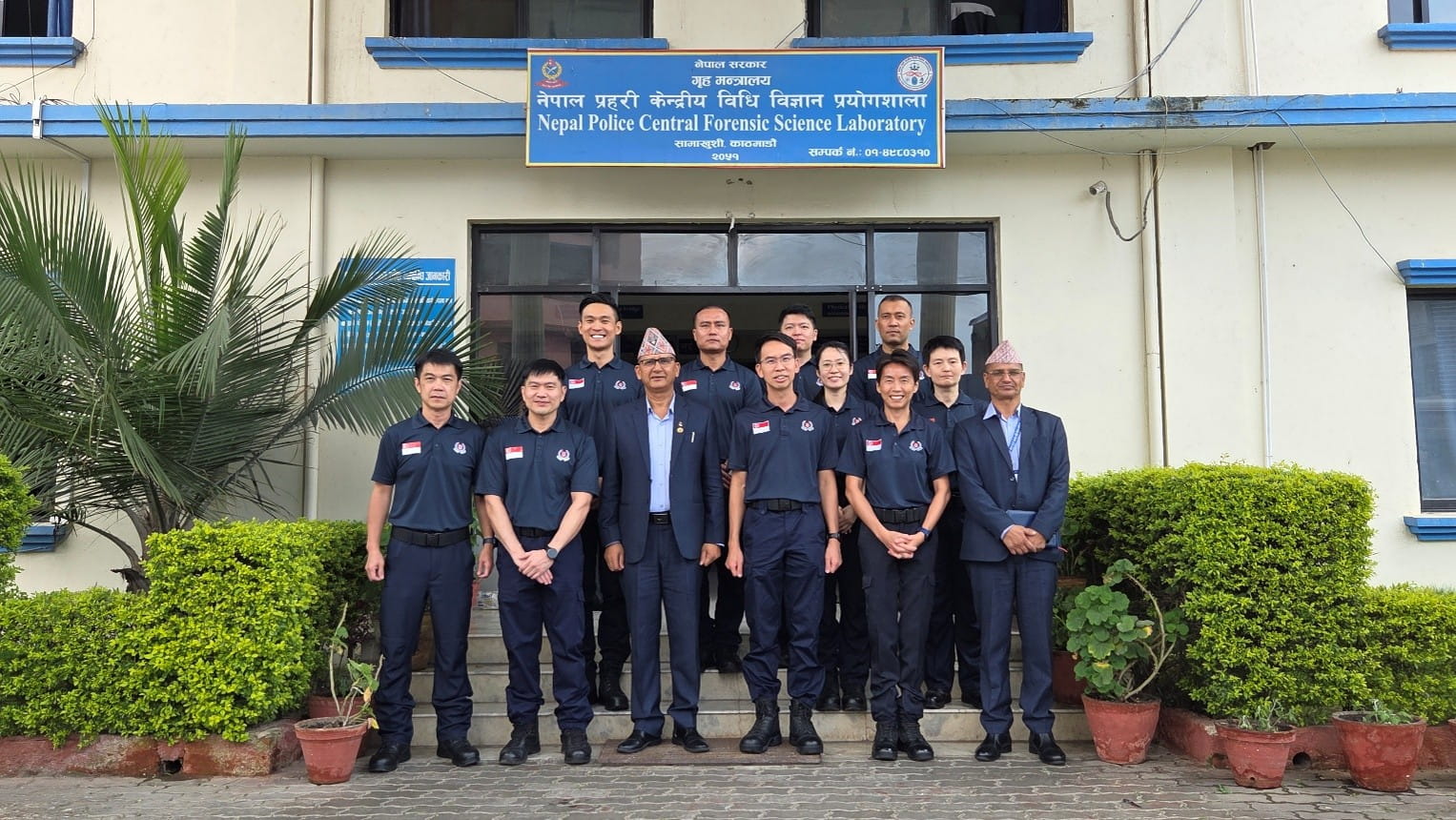 Group of officials posing outside Nepal Police Central Forensic Science Laboratory.