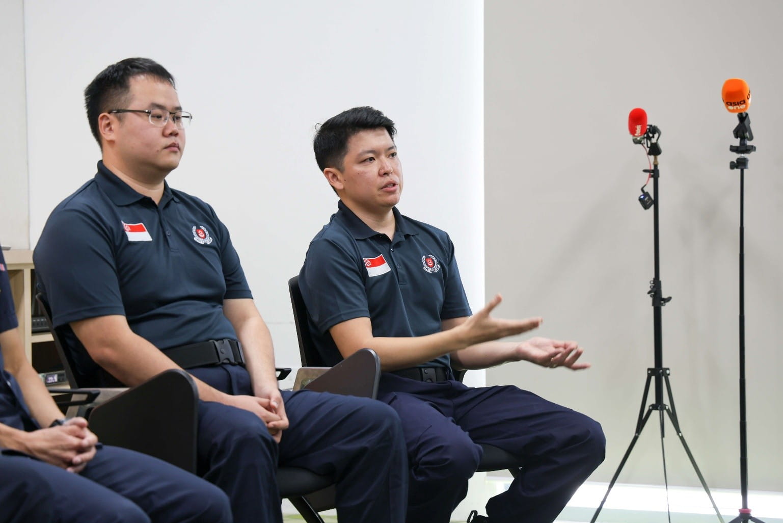 Men seated during an interview.