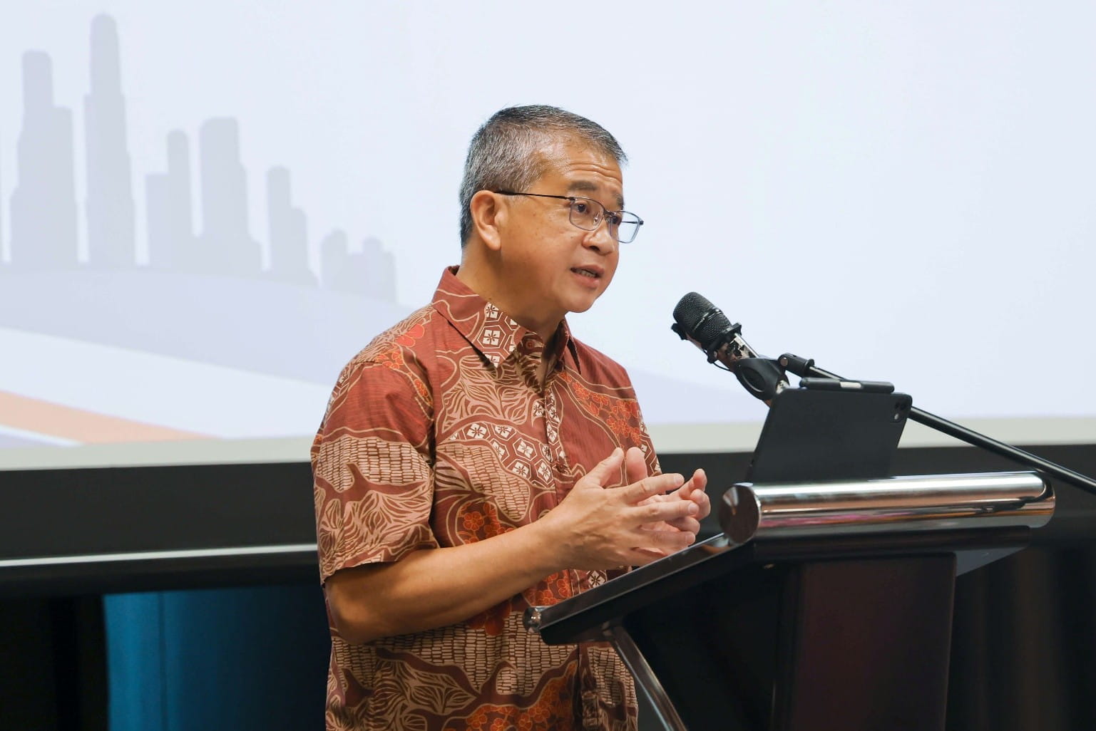 Man speaking at a lectern during the reception.