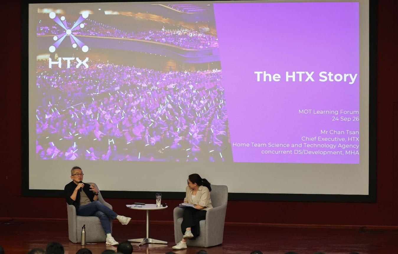 Two speakers seated onstage.