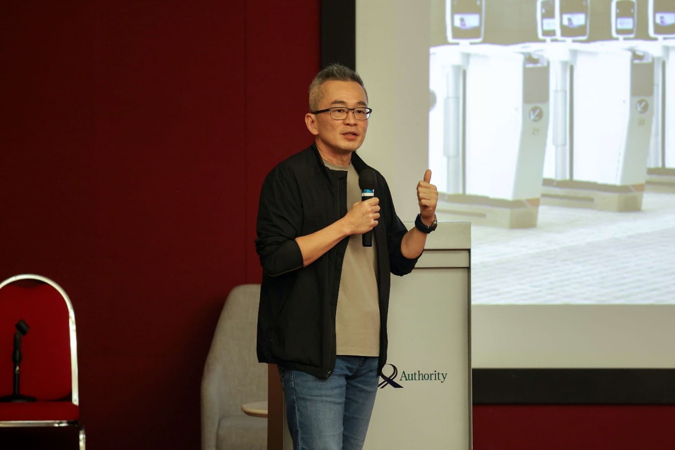 Speaker beside a podium during a technology presentation.