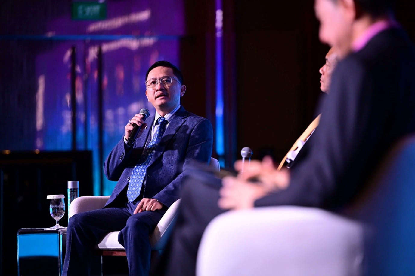 Man speaking at a panel discussion.