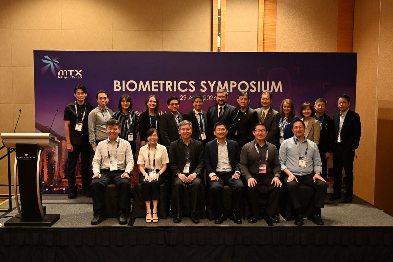 Group of people on stage for a photo.