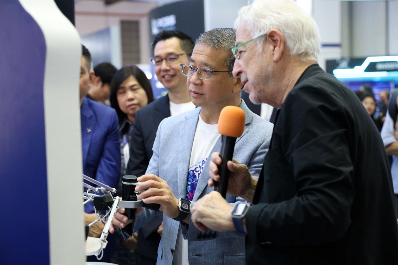 Group of people at a tech booth.
