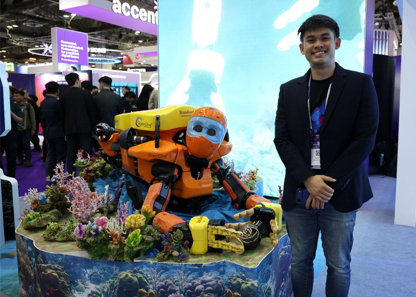 A man standing next to a robot.