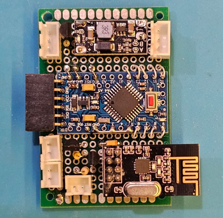 A close-up shot of a small green circuit board.