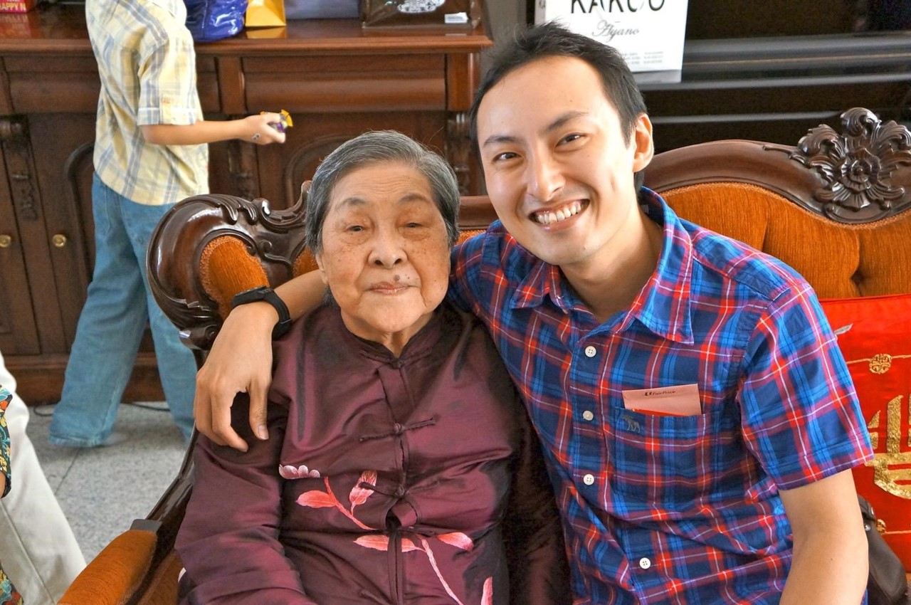 Elderly lady and man seated.