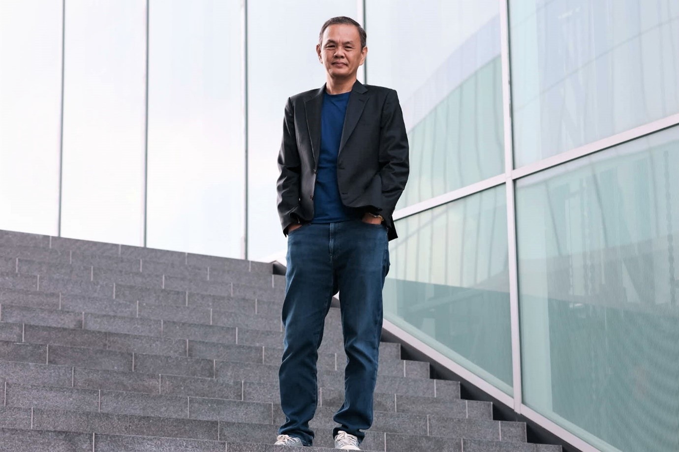 A man standing, posing for a photo.