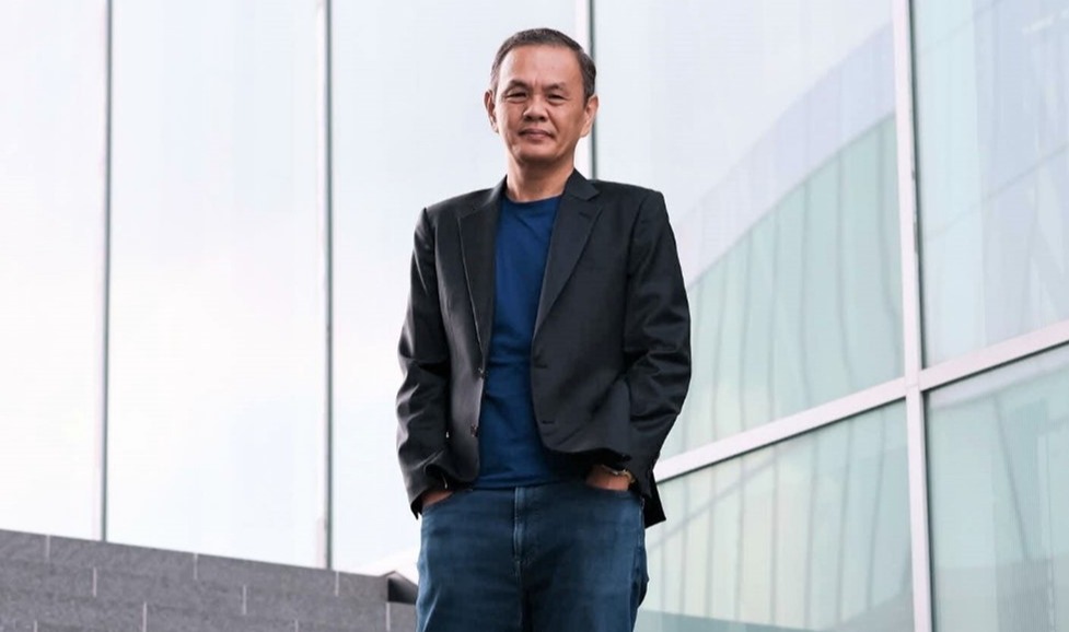 A man standing, posing for a photo.