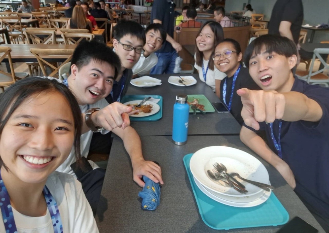 A group of people sitting at a table having their meal.