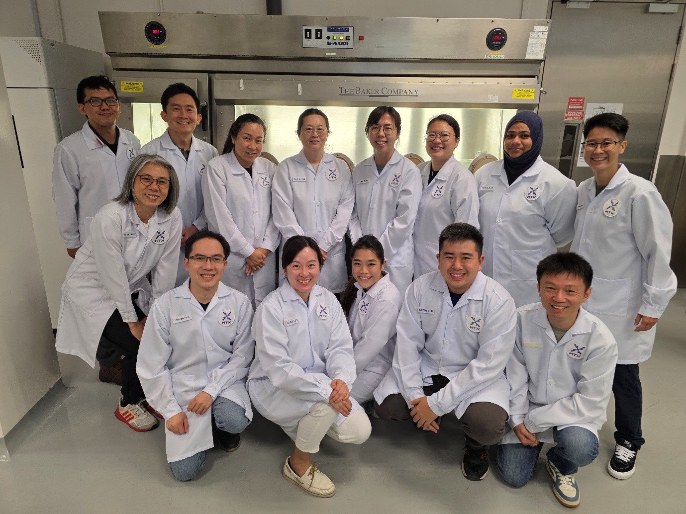 A group of people in lab coats posing for a photo.