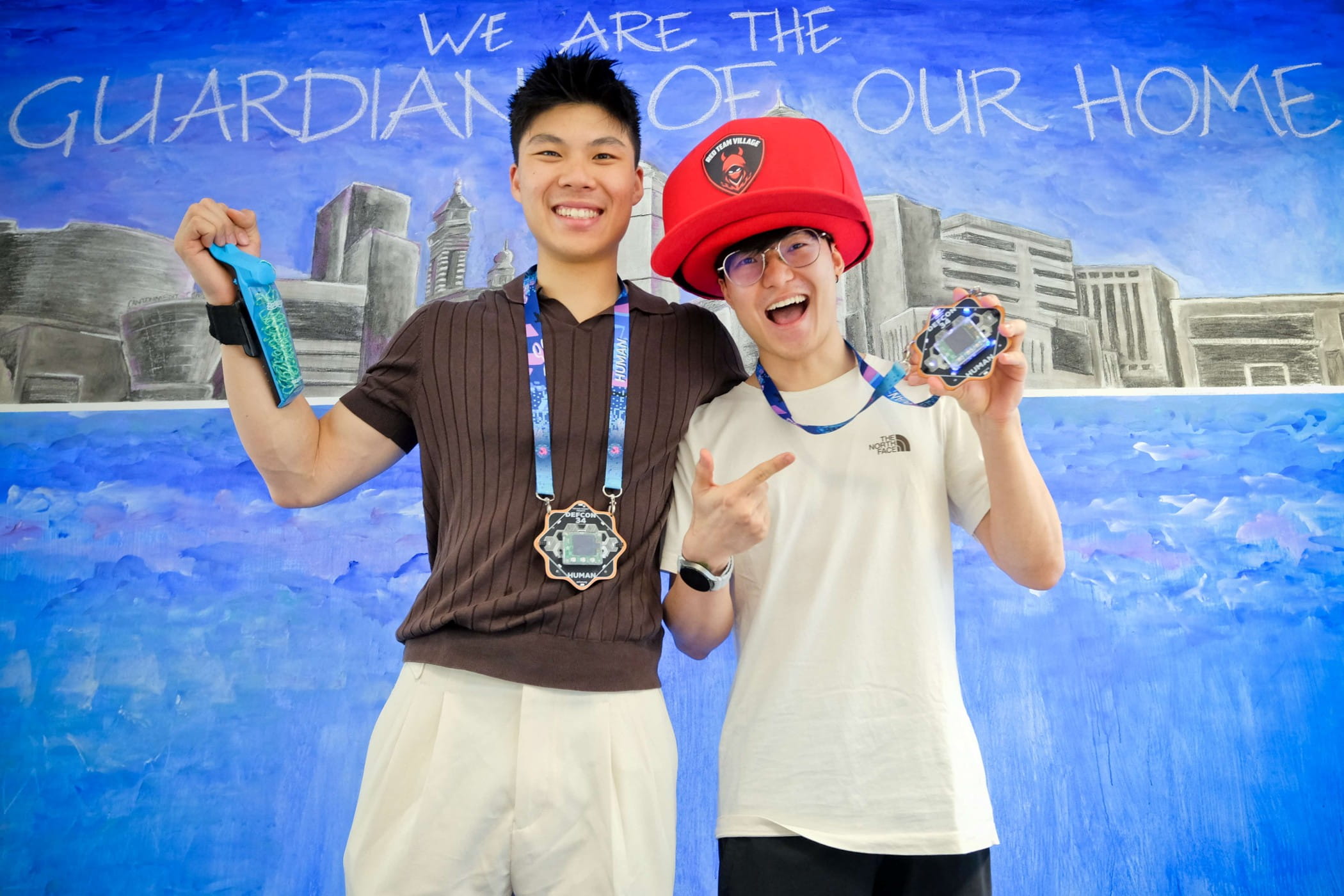 Two young men smiling and posing with their medals.