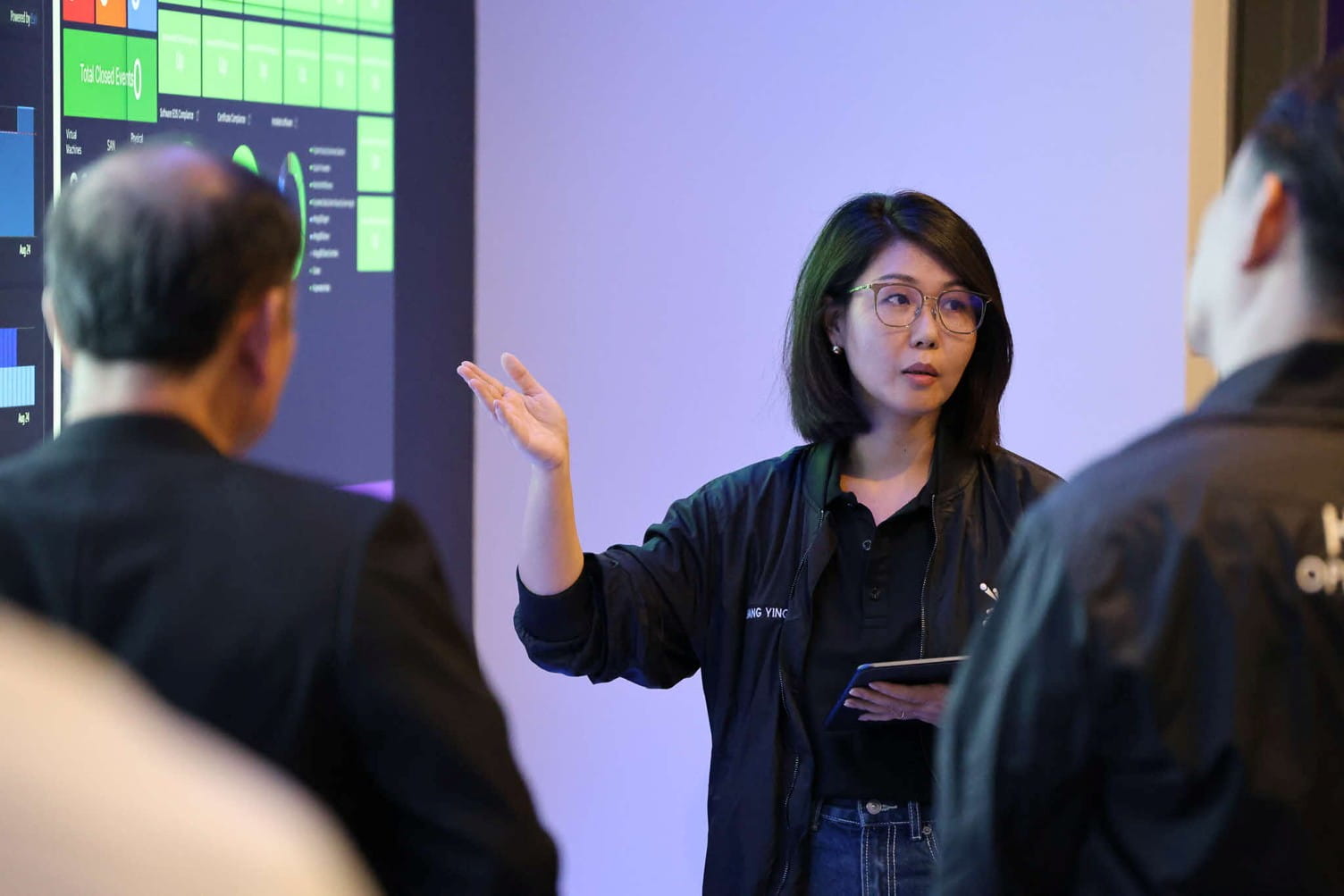 A woman presenting to colleagues.